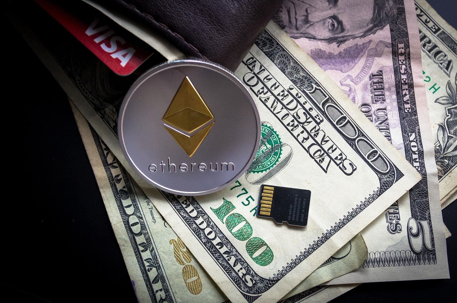 Ethereum coin beside euro notes